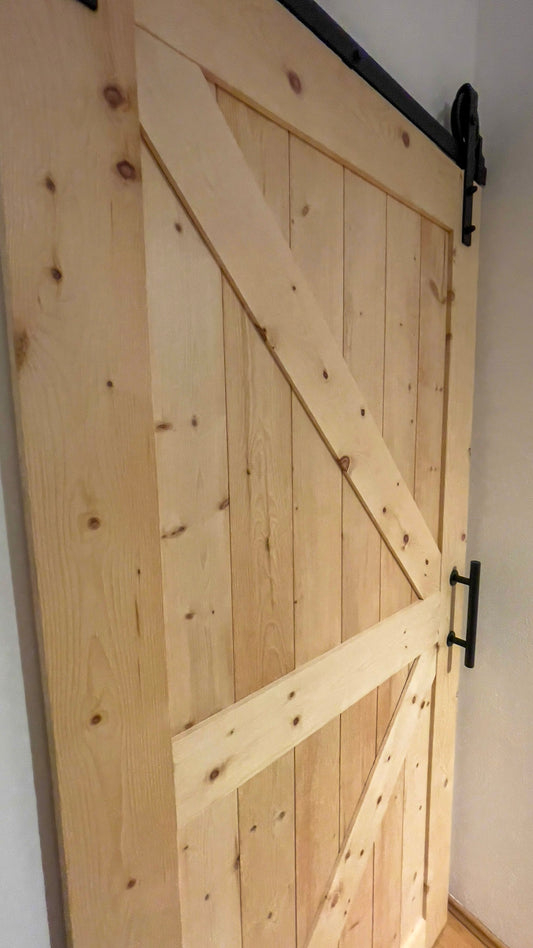 eine Holztür mit einem metallenen Griff daran